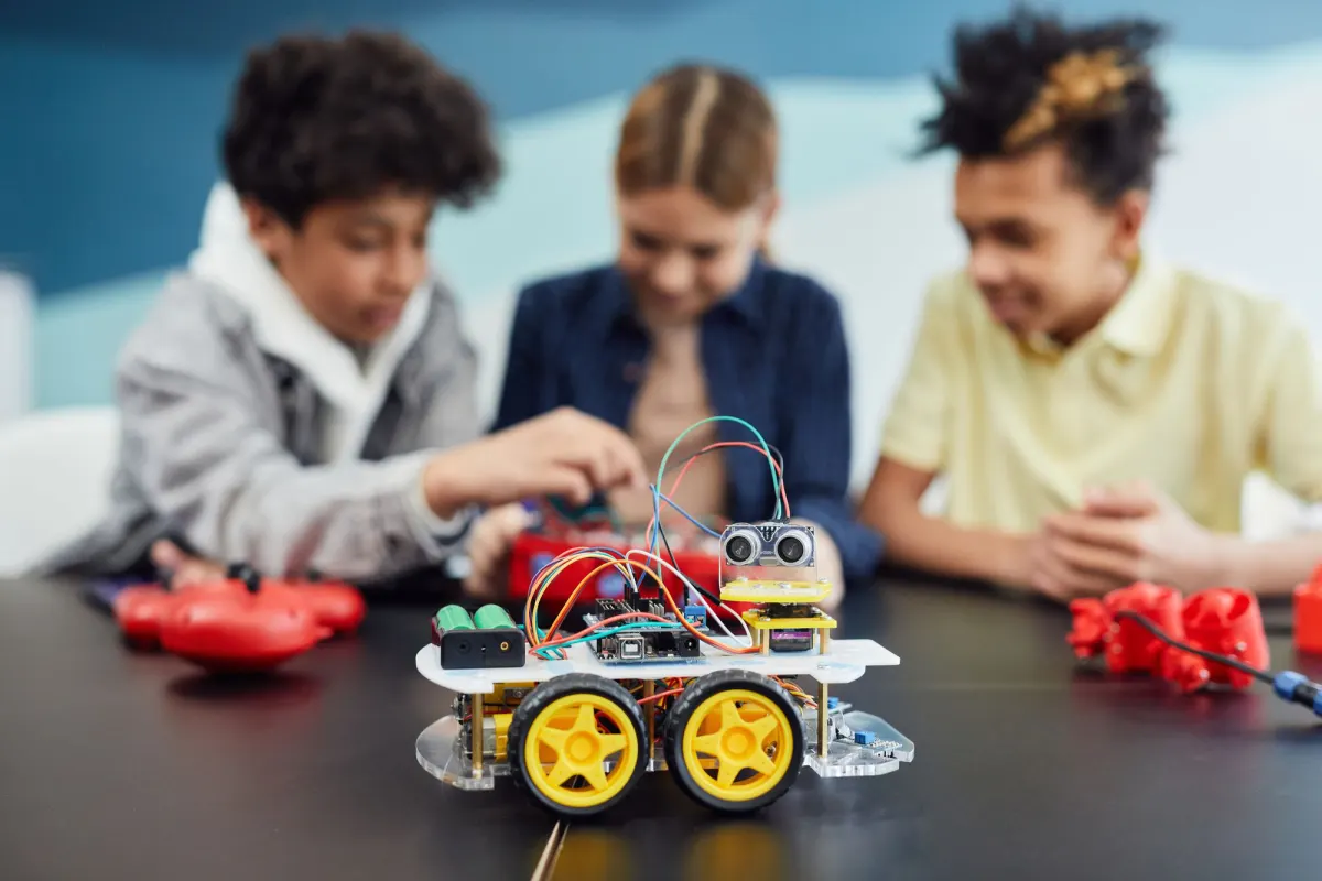 Students building a small robot together
